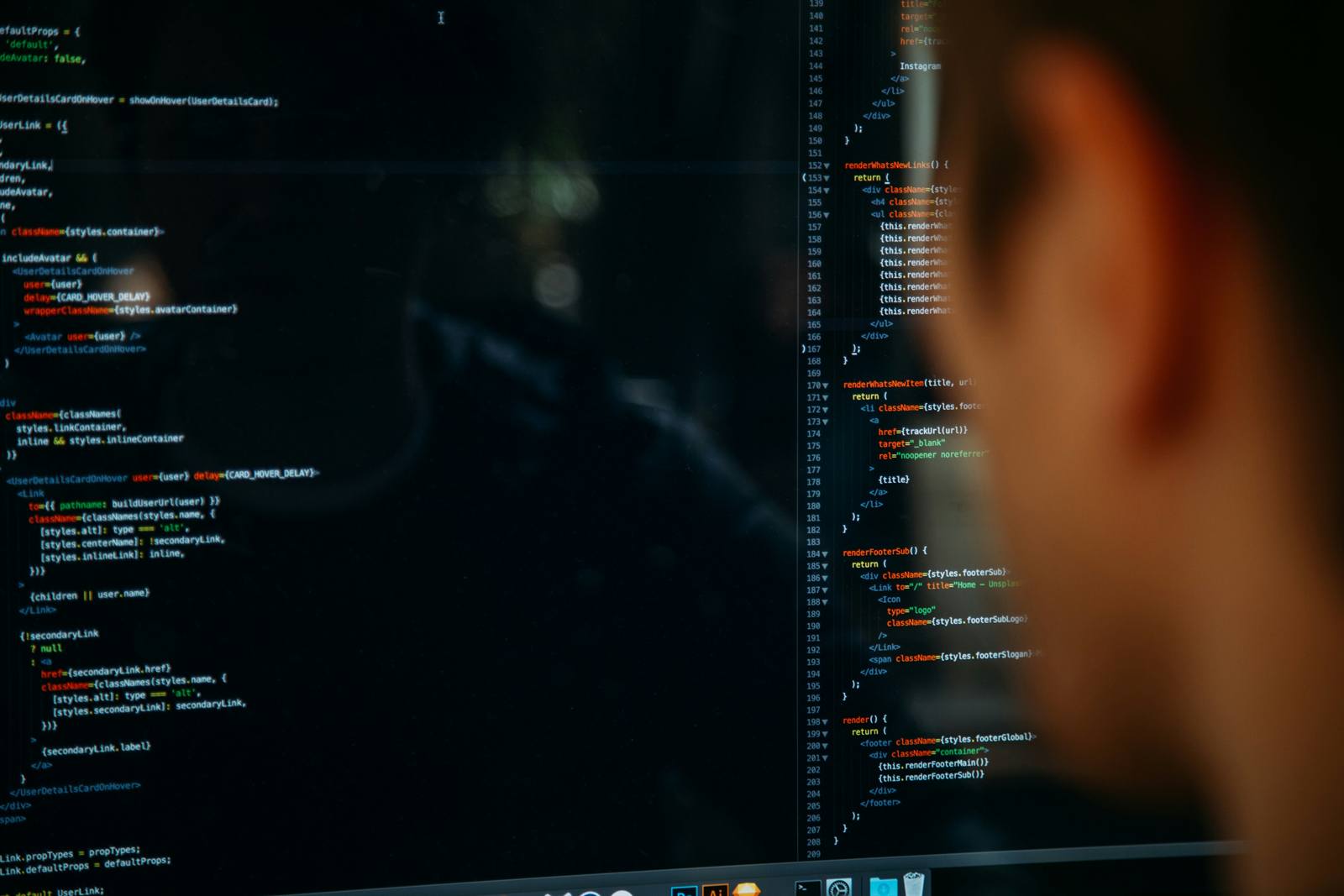 A developer's workspace, lit by code on a dark monitor.